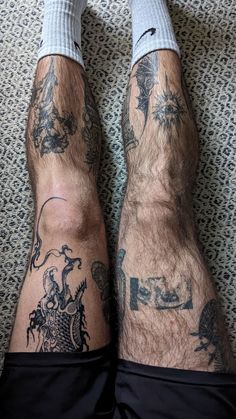 the legs and ankles of a man with tattoos