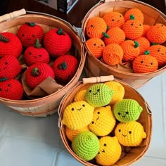 crocheted apples and oranges in baskets on a table