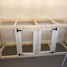 an unfinished kitchen cabinet is being built with the doors open and ready to be installed