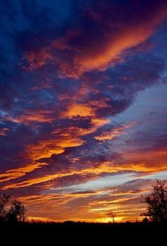 the sky is filled with colorful clouds as the sun sets