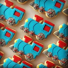 cookies decorated like trains and cars on a table