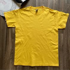 Gildan Adult Thick Heavy Cotton T-Shirt Daisy Yellow Size: M New Without Tags. Washed, Never Worn. Measurements Approx: Shoulder: 18” Shoulder To Hem: 27” Chest: 39” Weight: 5.5 Oz Material: 100% Cotton Made With Sustainably And Fairly Grown Usa Cotton Seamless Rib At Neck Taped Shoulder-To-Shoulder Double-Needle Stitching Throughout Classic Fit Please Contact Us With Any Questions Prior To Buying, Check Over All Measurements And Pictures. Smoke& Pet Free Environment. We Wrap, Protect, And Pack Solid Color Cotton T-shirt For Streetwear, Cotton Solid Color T-shirt For Streetwear, Basic Solid Color T-shirt For Streetwear, Crew Neck Solid Color T-shirt For Streetwear, Yellow Solid Color Shirt For Summer, Summer Yellow Solid Color Shirt, Solid Color Crew Neck T-shirt With Letter Print, Yellow Casual Solid Color Shirt, Casual Solid Yellow Shirt