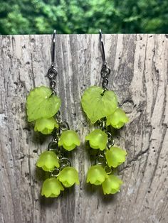 "Pretty, lightweight floral earrings! These have a magical, fae-like feel, perfect for nature lovers!  These earrings feature lime green flowers with semi-translucent lime green beads and lime green leaves. *Length (using default ear hooks): 2.75\"  *Weight (approx, each): 2.5g ✨Upgradable earring options available are: Gauge sizes are approximate. Some options may be in limited supply and may take additional time to ship.  *304 Steel mini hooks, silver color, 22 gauge (0.7mm). This is the perfe Green Earrings For Spring, Whimsical Green Dangle Earrings, Green Dangle Flower Earrings For Spring, Spring Green Dangle Earrings, Green Dangle Earrings For Spring, Green Dangle Jewelry For Spring, Green Spring Jewelry With Ear Wire, Spring Green Flower Earrings With Ear Wire, Spring Green Flower Earrings