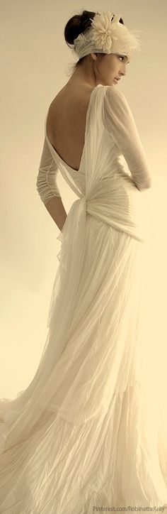 a woman in a white dress with her back to the camera