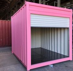 a large pink container sitting inside of a warehouse