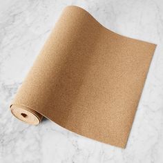 a roll of brown paper sitting on top of a white counter