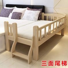 a wooden bed frame with white sheets and pillows on top of it in front of a wall