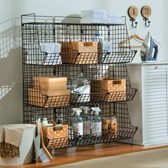 a metal shelf with baskets and towels on it