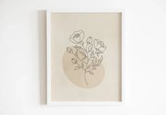 a white framed art print with flowers on it