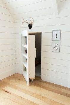 a room with white walls and wooden floors