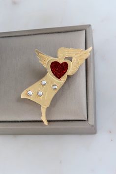 Vintage Newpro Angel with Red Heart Brooch. Length: 2 3/8" Width: 1 1/2" Vintage condition! Back to the shop: https://www.etsy.com/shop/SusVintage?ref=hdr_shop_menu Don't hesitate to contact me if you have any further questions. Thank you! Vintage Red Lapel Pin For Gift, Vintage Red Lapel Pin As Gift, Red Vintage Lapel Pin For Gift, Red Vintage Lapel Pin As Gift, Red Brooch For Anniversary On Valentine's Day, Red Brooches For Anniversary And Valentine's Day, Red Brooch Pins For Valentine's Day, Heart-shaped Brooch For Valentine's Day Anniversary, Heart-shaped Brooches For Valentine's Day Anniversary