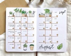 an open planner with plants on it and the words august written in cursive writing