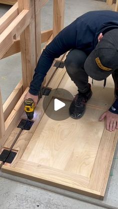 a man is working on a piece of wood