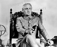 an old black and white photo of a man sitting in a chair