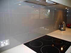 a kitchen counter top with a stove top oven next to an appliance on the wall