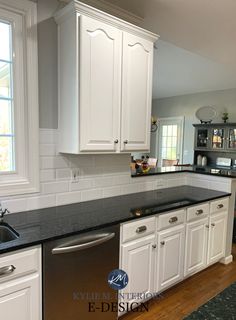 an empty kitchen with white cabinets and black counter tops is pictured in this image from the front view