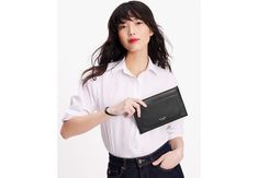 When you need only the essentials reach for the Ava wristlet. Crafted in pebbled leather this sleek silhouette keeps your cash cards and phone neatly on hand. | Kate Spade Ava Wristlet, Black Leather Wristlet, Embossed Logo, Women's Bags, Kate Spade New York, Pebbled Leather, Card Slots, Bags Women, Bags Handbags, Slots