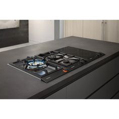 a black stove top sitting on top of a counter