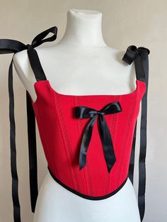 Red corset top with black bow ❤️🖤 Corset made in upcycling polo t shirt  *The straps are cut with a stitch and tied with bows🎀  *There is a black satin bow in the centre *There is a seam along the lines, an ornament in the form of leaves  *the corset has a cotton lining the corset is made in one copy ✅ Fits this size: for bust 33.1-35.8 inch (84-91cm)  waist 24.8-26.8 inch (63-68 cm) Fitted Party Tops With Ribbon, Red Underbust Corset For Summer, Red Fitted Top With Boned Bodice, Fitted Party Corset With Tie Straps, T Shirt Corset, Royal Suit, Corset Diy, Korsett Top, T Shirt Stencils