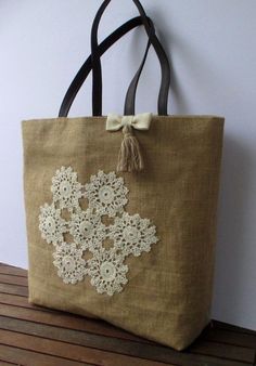 a brown bag with white lace on it sitting on top of a wooden table next to a wall