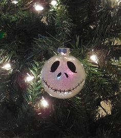 a glass ornament hanging from a christmas tree