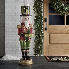 a christmas nutcracker is standing in front of a door