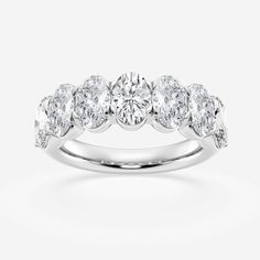 a white gold ring with five diamonds on it