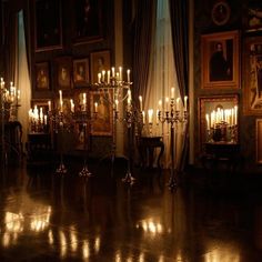 a room filled with lots of paintings and candles