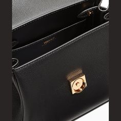 Versace top handle bag in leather. Signature tonal Medusa head at front. Rolled top handle. Removable, adjustable leather shoulder strap. Flap top with snap closure. Interior, slip pocket. Made in Italy. High-end Top Handle Flap Bag, Luxury Box Bag With Branded Hardware For Office, Luxury Flap Bag With Gold-tone Hardware And Top Handle, Luxury Flap Tote Bag With Top Carry Handle, Luxury Tote Flap Bag With Top Carry Handle, Luxury Flap Bag Tote With Top Carry Handle, High-end Office Box Bag With Branded Hardware, Classic Rectangular Bags With Branded Hardware, Classic Rectangular Bag With Branded Hardware