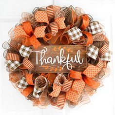 an orange and white wreath with the words,'thank you'written on it