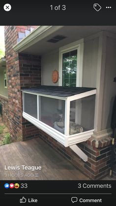 an open window on the side of a house with a dog laying in it's bed