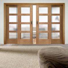 an empty room with two wooden doors and carpet