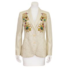 Interesting and very visual Moschino Cheap and Chic blazer from the early 1990s. Cream ecru cotton with all over abstract beige chevron top stitching. The blazer is further embellished with chartreuse grosgrain ribbon in the the shape of spirals and flowers with a mix of tiny and large multicolour glass beads throughout. Body is lined in a thin tonal cotton. A wearable piece of art! Excellent vintage condition. Made in Italy. Fits like a US size 8. Sleeve 23" Shoulder 16" Bust 38" Waist 35" Hips Italy Fits, Chevron Top, Chic Blazer, Cream Jacket, Crochet Bolero, Moschino Cheap And Chic, Leather Trench Coat, Lingerie Dress, Couture Collection