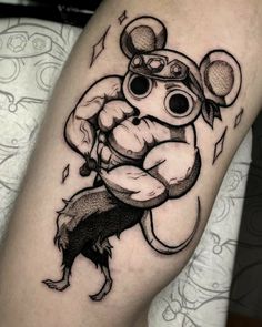 a cartoon character tattoo on the leg, with an evil looking mouse holding a baseball bat