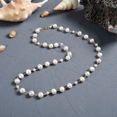 "A single-strand necklace featuring lustrous white pearls in a sequence of small and large pearls. The pearls are wired with non-tarnish gold tone wire. Pearl size: 2-3MM and 9-10MM: great luster. Necklace Length: 28\" L. Major Beads/material: mixed metal type: 1. wire: Tarnish-resistant gold-tone wire. Clasp: Vermeil lobster claw clasp and jump ring. Workmanship: Each bead is wire beaded. https://www.etsy.com/shop/MYGEMSROCK" Classic White Beaded Chain Necklace, Pearl White Beaded Necklaces With Baroque Pearls, Pearl White Beaded Necklace With Baroque Pearls, Pearl White Beaded Necklaces For Jewelry Making, Pearl Necklaces With Round Beads, Baroque Pearl Beaded Necklace With Round Beads, Classic Pearl Necklace With Beaded Chain, Classic Pearl Necklace With Round Beaded Chain, Classic Pearl Necklace With Beaded Chain For Gift