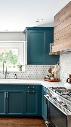 a kitchen with teal cabinets and white counter tops is pictured in this image from the front view