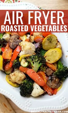 a white bowl filled with vegetables on top of a wooden table