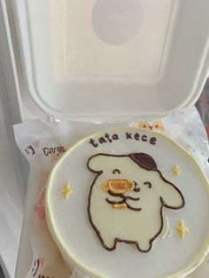 there is a cake in the shape of a dog on it's plate with writing