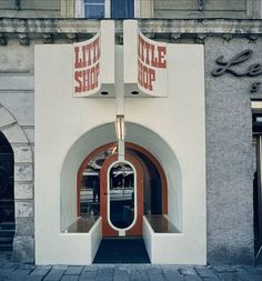 an entrance to a little shop on the side of a building