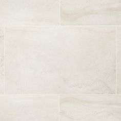 a tile floor with white marble tiles on it