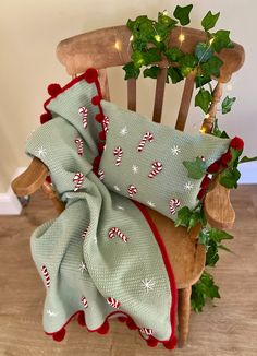 a wooden rocking chair with christmas decorations on it