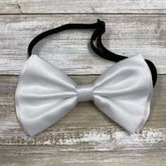 "Adults/Teens Elastic Suspender, Bow-tie All dimensions are approximate only Suspender Dimensions: Wide : 1.5\" (3.81cm) Adjustable from 25\" 63.5cm - 38\" (96.52cm) Bow Tie Dimensions: Length: 12cm (4.7 inches) Height (Widest Point): 6cm (2.36 inches) Height (Narrowest Point): 2.3cm (0.90 inches) Length of Bow Tie Strap at full length: 48cm (18.89 inches)" Adjustable White Bow Tie Back, White Adjustable Bow Tie Back, White Standard Bow Tie, Adjustable White Bow Tie, Adjustable White Bow Tie With Decorative Bow, White Adjustable Standard Bow Tie, Adjustable White Satin Bow Tie, Adjustable White Satin Bow, Adjustable White Bow For Black Tie Occasion