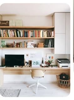 a desk with a computer, bookshelf and other items on top of it