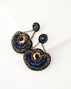 Big statement dangle earrings in blue and gold color combination. Each bead and swarovski crystal is hand stitched very precisely to create this “great Gatsby” inspired bohemian beaded jewelry. Very unique, dramatic and feminine Statement making and medium weight Hand embroidered front and smooth suede back Perfect jewelry to elevate special occasion, evening, ball, gala, wedding guest, bridal and bridesmaids dresses Earrings can become unique Christmas gift for someone special Material: Swarovs Blue Beaded Chain Earrings For Party, Handmade Blue Chandelier Earrings, Party Blue Beaded Earrings With Gold Beads, Bohemian Embellished Beaded Earrings For Party, Bohemian Embellished Beaded Earrings, Bohemian Beaded Jewelry, Gold Color Combination, Great Gatsby, Unique Christmas Gifts