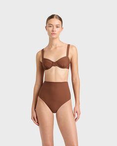 The Lori balconette bikini top in Cocoa brown is cut from our luxury, Italian Sculpteur® fabric. Lori features an underwire for bust support, flattering gathers at mid bust and wide, comfortable, adjustable shoulder straps and a branded back-clip. A beautiful, classic piece that will part of your swimwear wardrobe for years to come, Best suited to bust sizes B to D. Luxury fabric sustainably made in Italy. Brown Underwire Swimwear For Vacation, Brown Underwire Swimwear For Poolside, Brown Underwire Swimwear For The Beach, Brown Seamless Swimwear For Vacation, Brown Beachwear Swimwear With Adjustable Straps, Brown Seamless Swimwear For Pool, Brown Seamless Swimwear For Sunbathing, Second-skin Swimwear With Built-in Bra And High-cut Leg, Brown Triangle Top Swimwear With Adjustable Straps