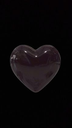 a heart shaped object is shown in the dark