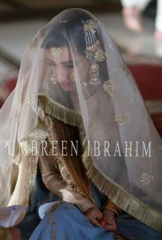 a woman wearing a veil and sitting down