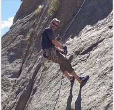 a man climbing up the side of a mountain