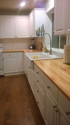 the kitchen is clean and ready for us to use it's counters are made of wood