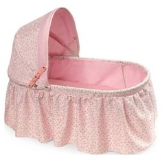 a baby's pink bassinet is shown with the cover pulled up to it's side